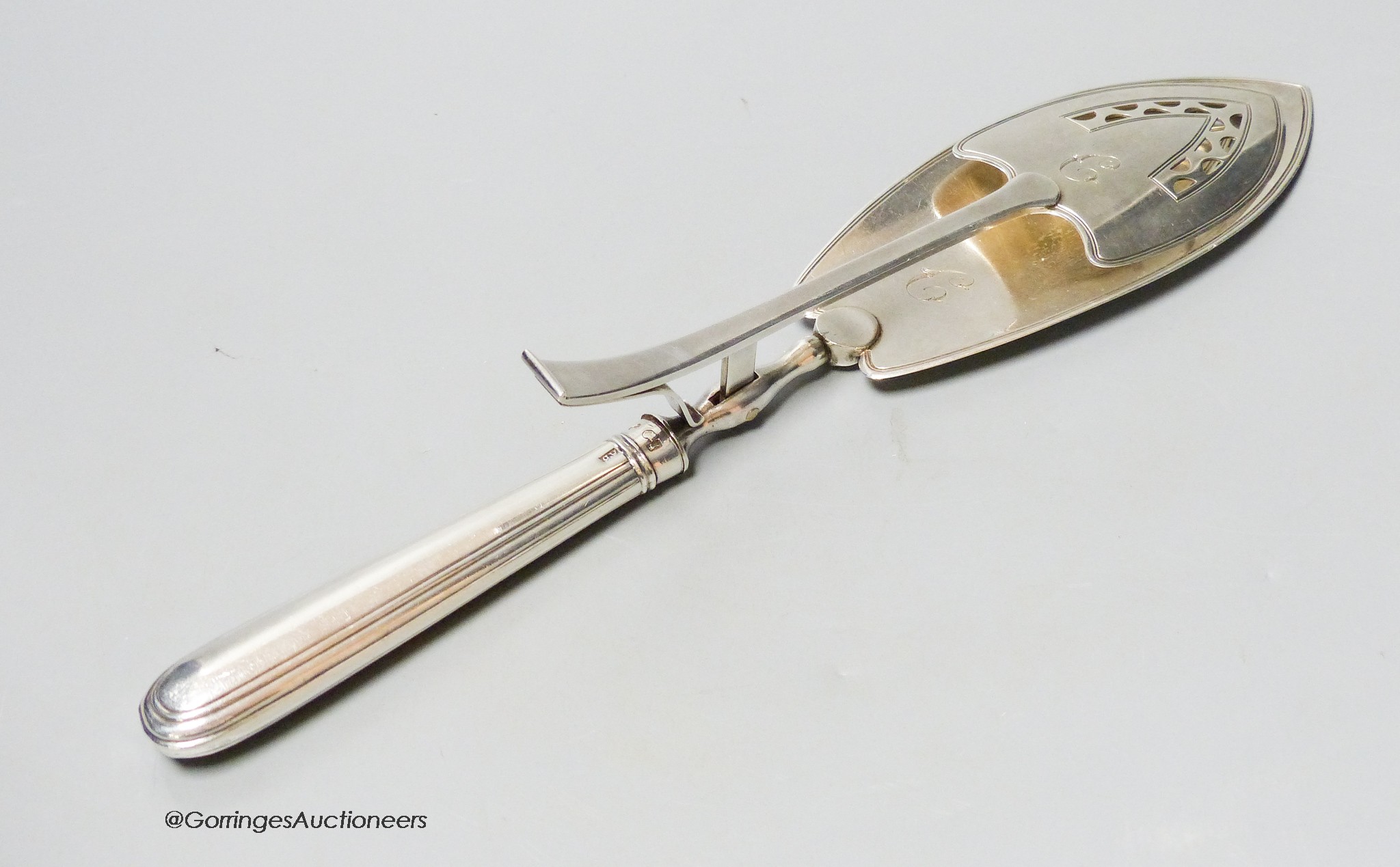 A pair of George III silver navette shaped serving tongs, Peter, Ann & William Bateman, London 1802, 30.3cm, loaded handle, gross 203 grams.